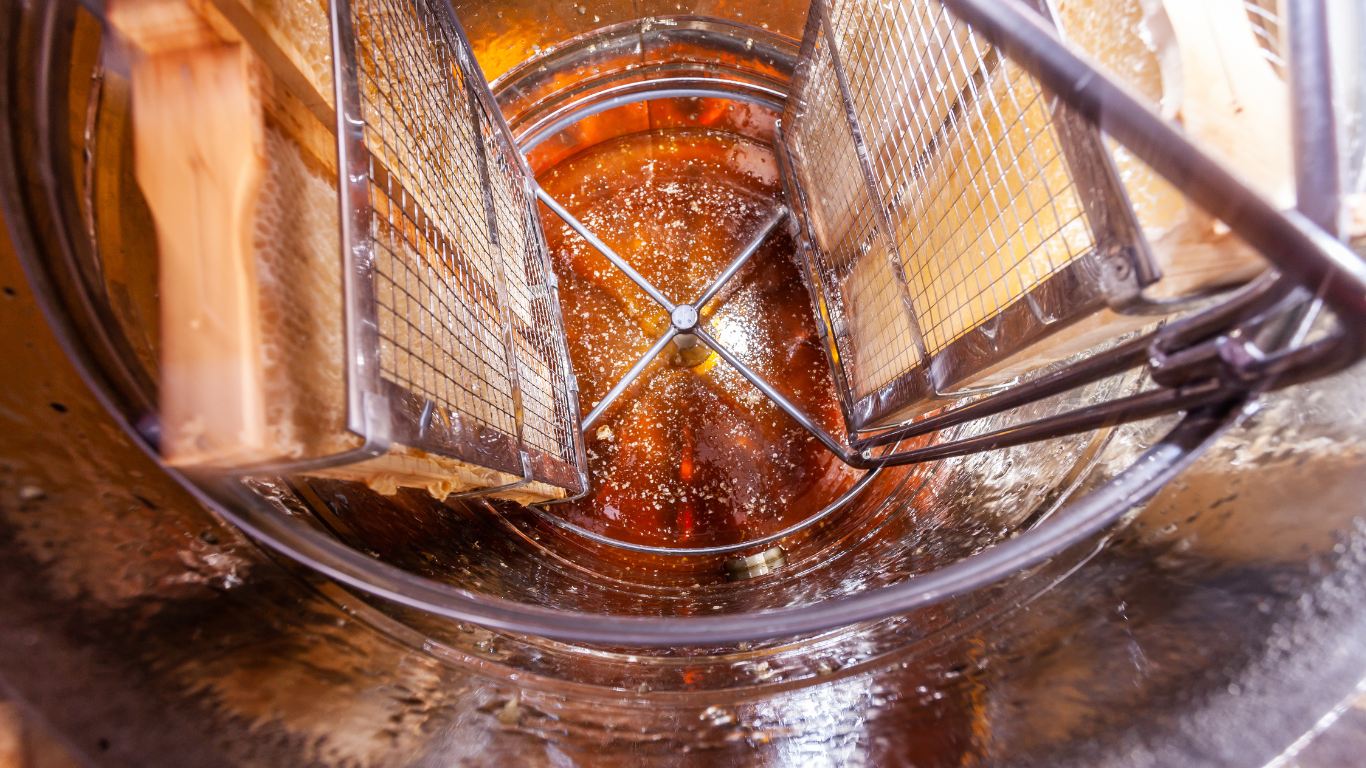 Beekeeper extracting honey from honeycomb using a honey extractor.