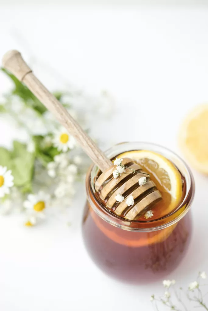 Canadian wildflower honey in a glass jar with natural golden color