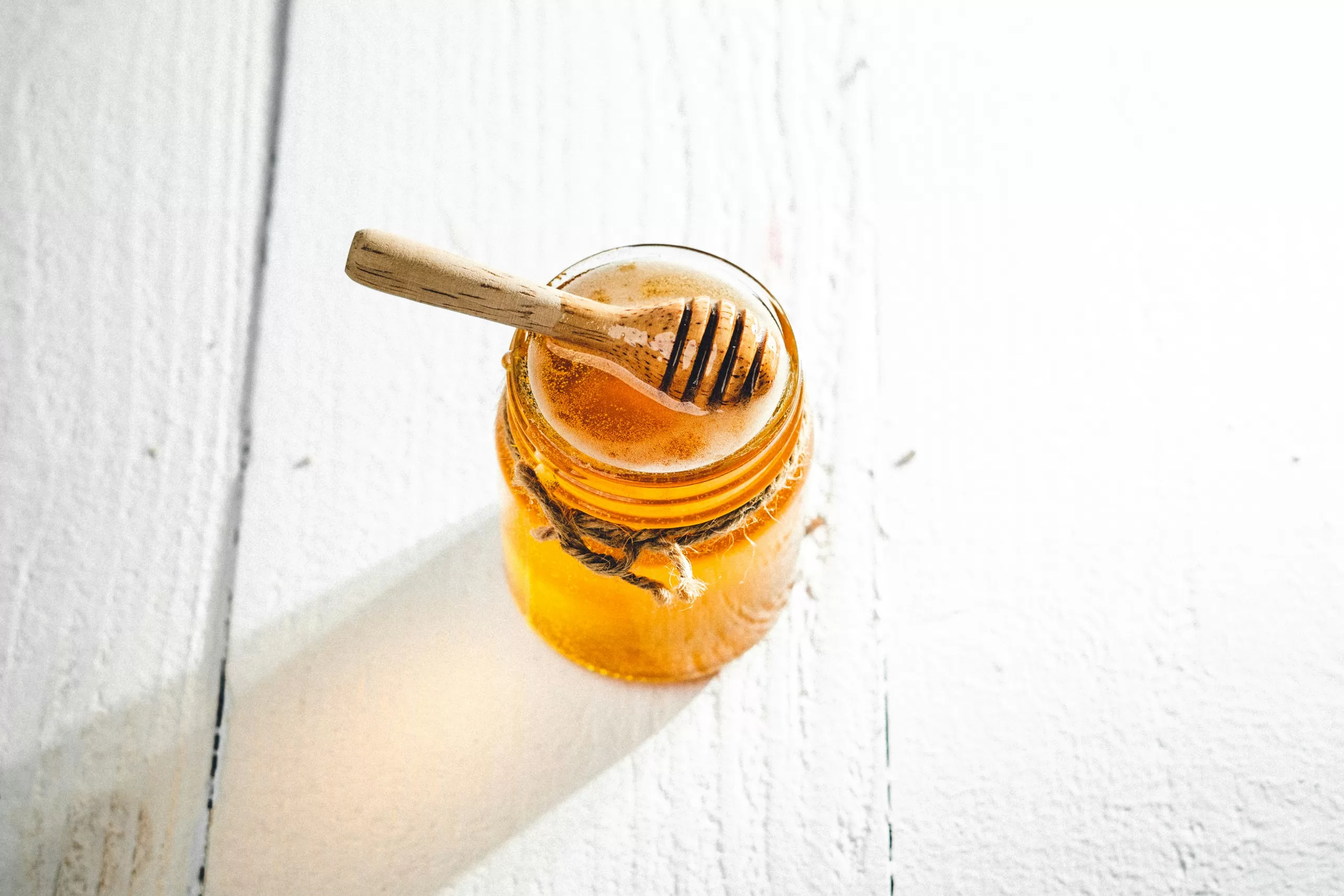 Canadian honey in a glass jar showing light color and natural clarity